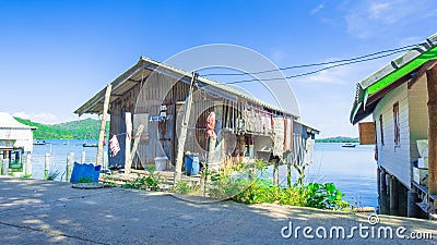 Traditional wooden house and Modern house roadside of fisherman village. Stock Photo