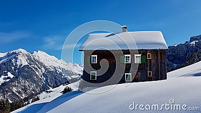 Traditional wooden mountain hut in beautiful winter landscape. Walsertal, Vorarlberg, Austria. Stock Photo