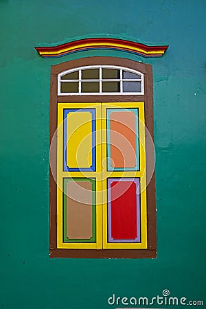 Traditional wooden window with leaf doors closed and colourful combination Stock Photo