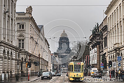 City life and architecture: a traditional yellow tram with the Palais de Justice Law Court of Bruxelles, Zavel neighbourhood Editorial Stock Photo