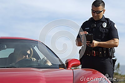 Traffic Cop By Sports Car Stock Photo