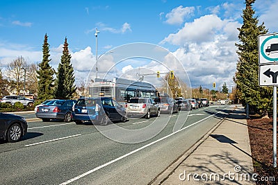 Traffic driving across the city. Cars moves on a city road on a sunny day. Traffic light on a highway in BC Canada Editorial Stock Photo