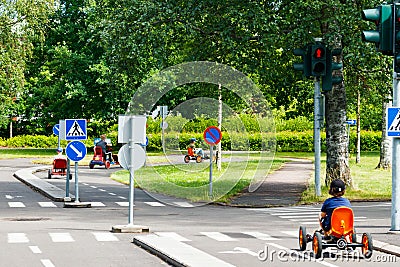 Traffic educational experience - practice park for children. Mini car road, traffic sign and traffic light Editorial Stock Photo