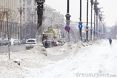 Winter service vehicle cleaning the street and sidewalk clean of snow Editorial Stock Photo