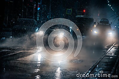 Traffic on a heavy snowfall and rainy night Stock Photo