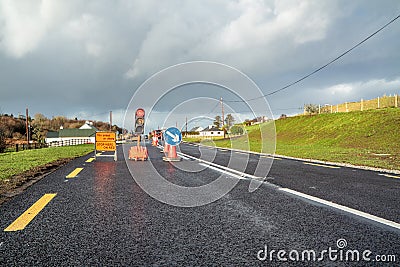 Traffic light counting down at road construction site Stock Photo