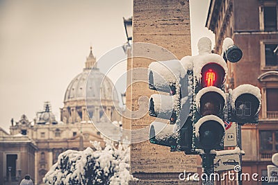Traffic light covered with snow. Saint Peter, Rome Italy. Stock Photo