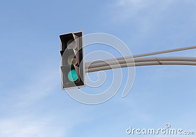 Traffic light with green signal against blue sky Stock Photo