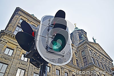 Traffic light with Royal Palace in the background at Dam Square Stock Photo