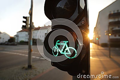 A traffic light shows green bicycle symbol at an european intersection in uplifting and inspiring morning light Stock Photo
