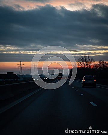 Traffic on the main highway through the landscape of SkÃ¥ne Scania in southern Sweden during a winter sunset Stock Photo