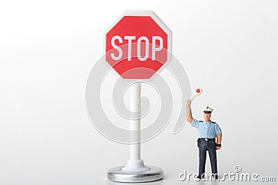 Traffic officer miniature figurine with a stop sign Stock Photo