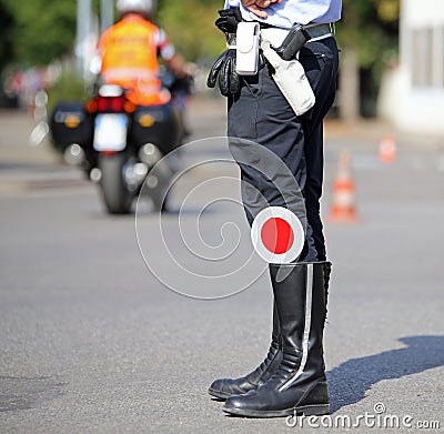 traffic pallet in the black boots of a traffic warden in the cit Stock Photo