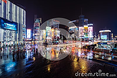 Traffic and people walking on crosswalk at Ximending with falling rain in Taipei, Taiwan. Ximending is the famous fashion, night Editorial Stock Photo