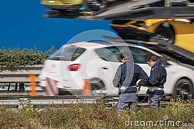 The traffic police check the speed of vehicles on the side of the highway with a speed camera Editorial Stock Photo