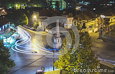 Traffic on roundabout street in city of Vranje at night Stock Photo