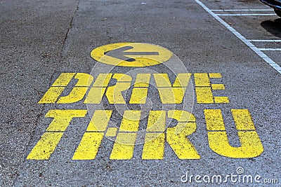 Drive thru traffic sign painted on yellow asphalt Stock Photo