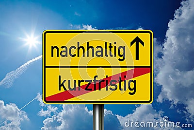 Traffic sign with blue sunny sky in the background with the german words for sustained and short term - nachhaltig und kurzfristig Stock Photo