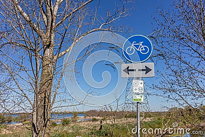 Traffic sign: cycle lane in both directions, blue and white round plate, cycle routes 4 and 13 Stock Photo