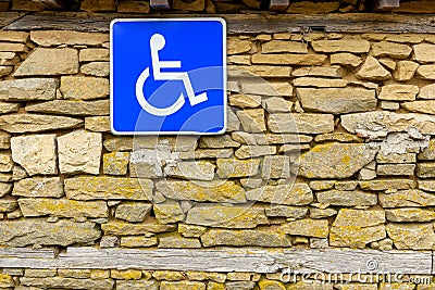 Stone wall and disabled access Sign, handicap accessible sign Stock Photo