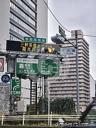 Traffic signs in tokyo showing the direction to Ginza Shibuya and Haneda area Editorial Stock Photo