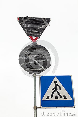 Traffic signs wrapped in black plastic Stock Photo