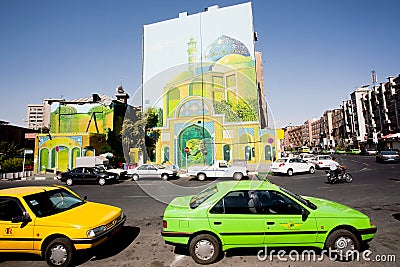 Traffic on sunny road with colorful taxi cars and street art on the building wall Editorial Stock Photo