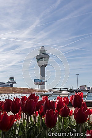 Traffic tower Schiphol airport with tullips in the foreground Editorial Stock Photo