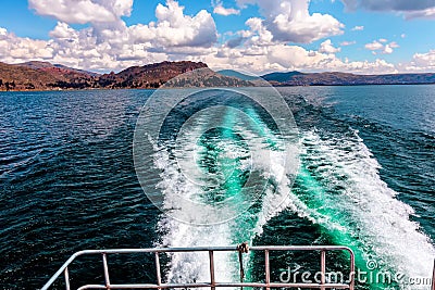 Trail behind the boat on water surface , Lake Titicaca - the highest navigable Lake in the World. Peru Stock Photo