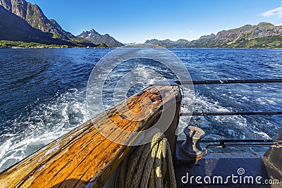 Trail behind of the ship on water surface on Trollfjord Stock Photo