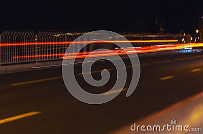 Trail brake lights of a car at night in the city Stock Photo