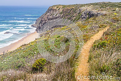 Trail, Cliffs, beach and waves in Arrifana Stock Photo