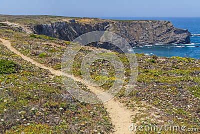 Trail, Cliffs, beach and waves in Arrifana Stock Photo