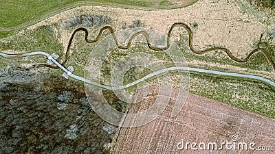 A trail follows a stream in springtime Stock Photo