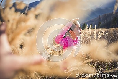 Trail running athlete exercising for fitness. Young woman smiling runner run in nature in mountains. Stock Photo