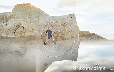 Man running in mountains on the sunrise Stock Photo