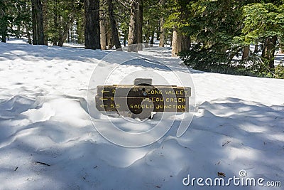Trail sign almost buried in snow, Mount San Jacinto State Park, California Stock Photo