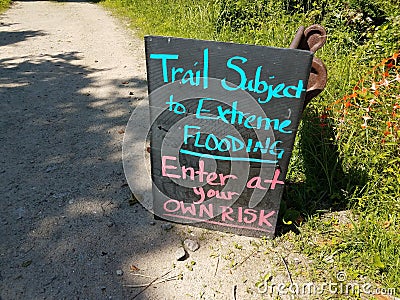 trail subject to flooding sign on trail or path Stock Photo