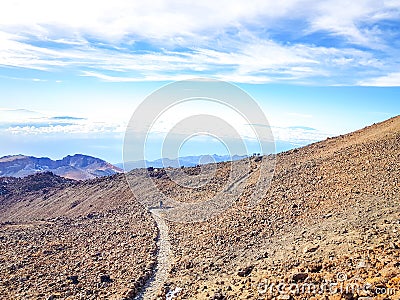 Trail at the top of the Teide with view of the caldera and the island of Tenerife Stock Photo