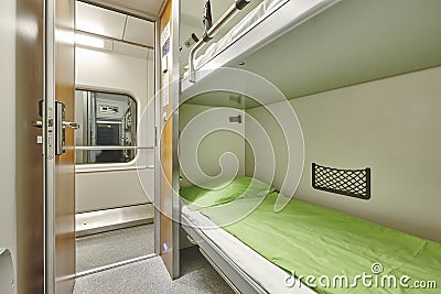 Train berth corridor indoor with two beds. Travel background. Stock Photo