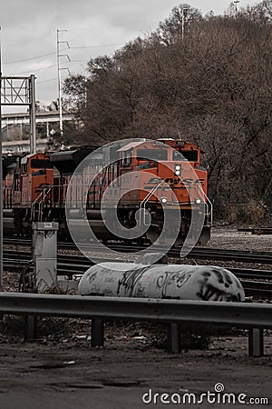 Train on BNSF railroad during a winter day with wood trees Editorial Stock Photo