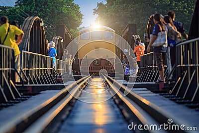 Train on the bridge over the river Kwai in Kanchanaburi, Thailand. This bridge is famous for its history in second world war Stock Photo