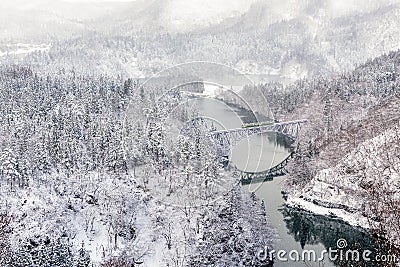 Train on the bridge over Tadami river in Japan Stock Photo