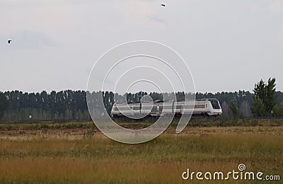 Train circulating on the track in the field Stock Photo