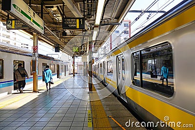 The train coming to the station in Jimbocho, Tokyo, Japan Editorial Stock Photo