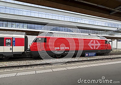 Train composed of SBB-CFF-FFS Re 460 locomotive SBB Re 460 and SBB 61 85 wagons 10-90 225-6 APM. Famous for its longevity, durab Editorial Stock Photo