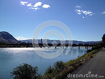 Train crossing a bridge across the north Thompson river in beaut Stock Photo