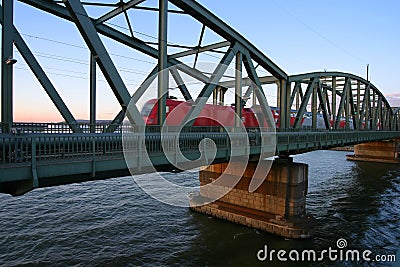 Train crossing bridge over river Stock Photo