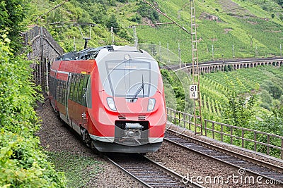 Train driving along german river Moselle Stock Photo