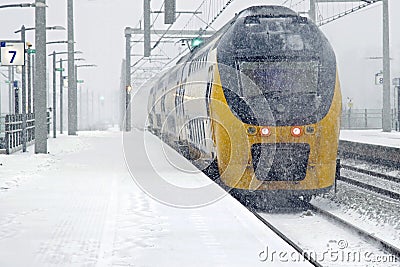 Train driving in snowstorm in winter in Amsterdam Netherlands Stock Photo